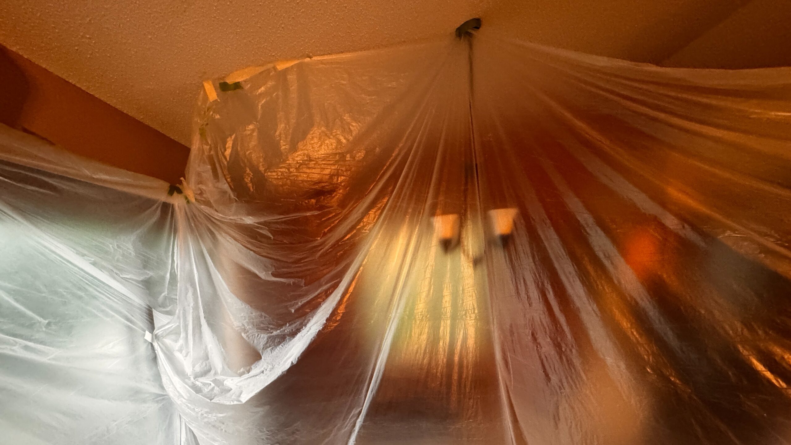 Minnesota home interior taped off to protect furniture during renovation
