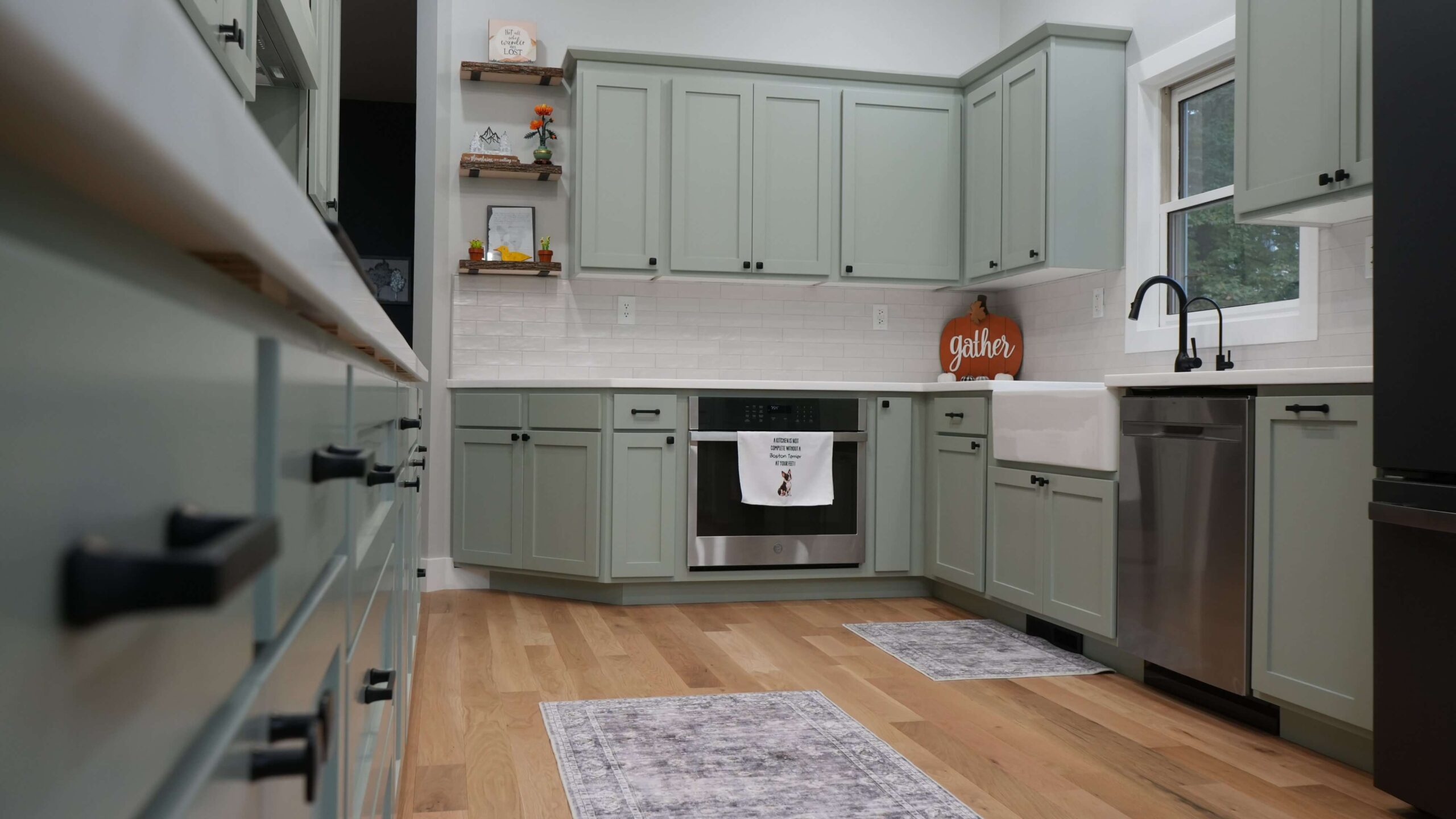 Restored and fully renovated green cabinets kitchen after water damage in Forest Lake, MN	