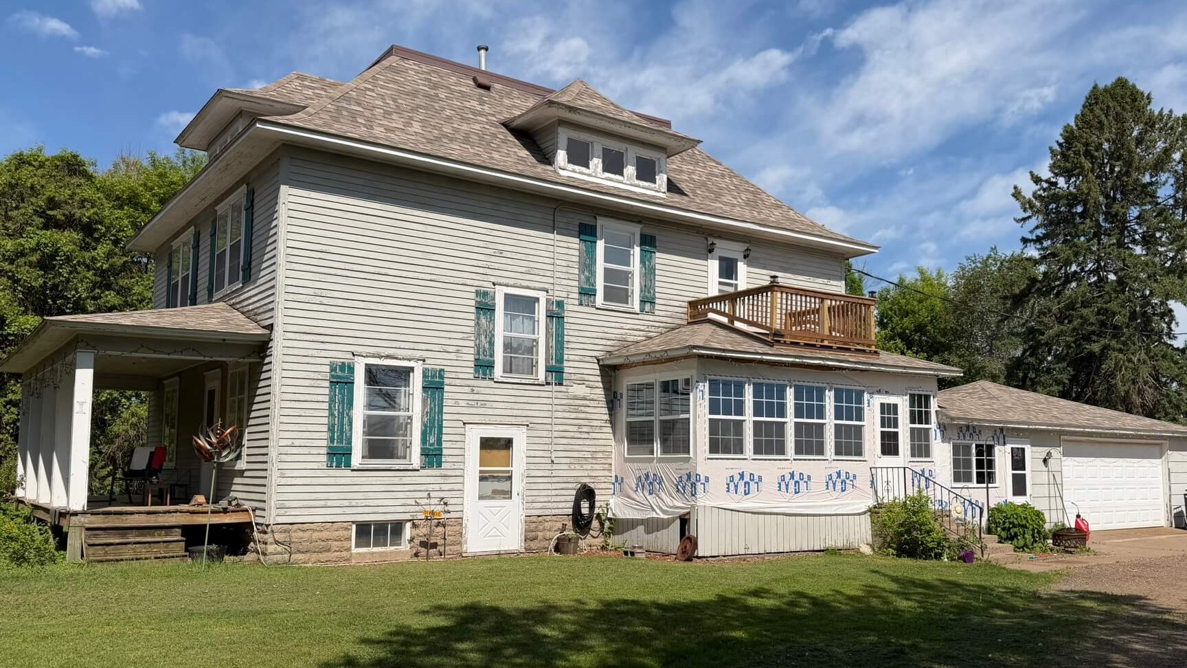 Minnesota Exterior Company inspecting a 1919 farmhouse for new siding and gutters
