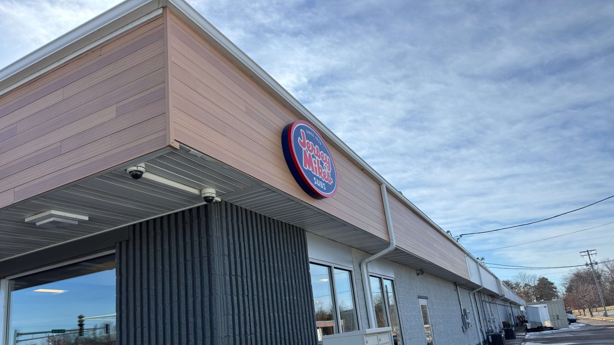 Professional Exteriors Inc. replaced custom Jersey Mike siding for local Forest Lake sandwich shop