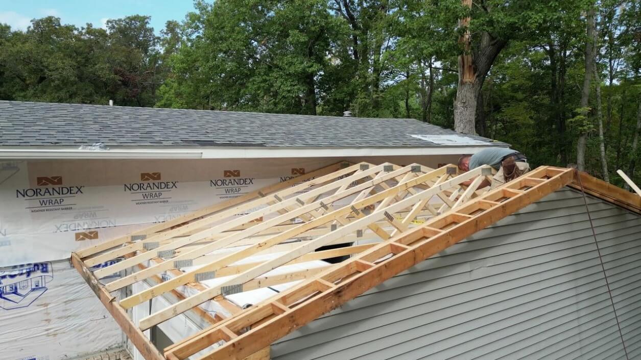 Minnesota Exterior Company removing garage roof after tree fall damage