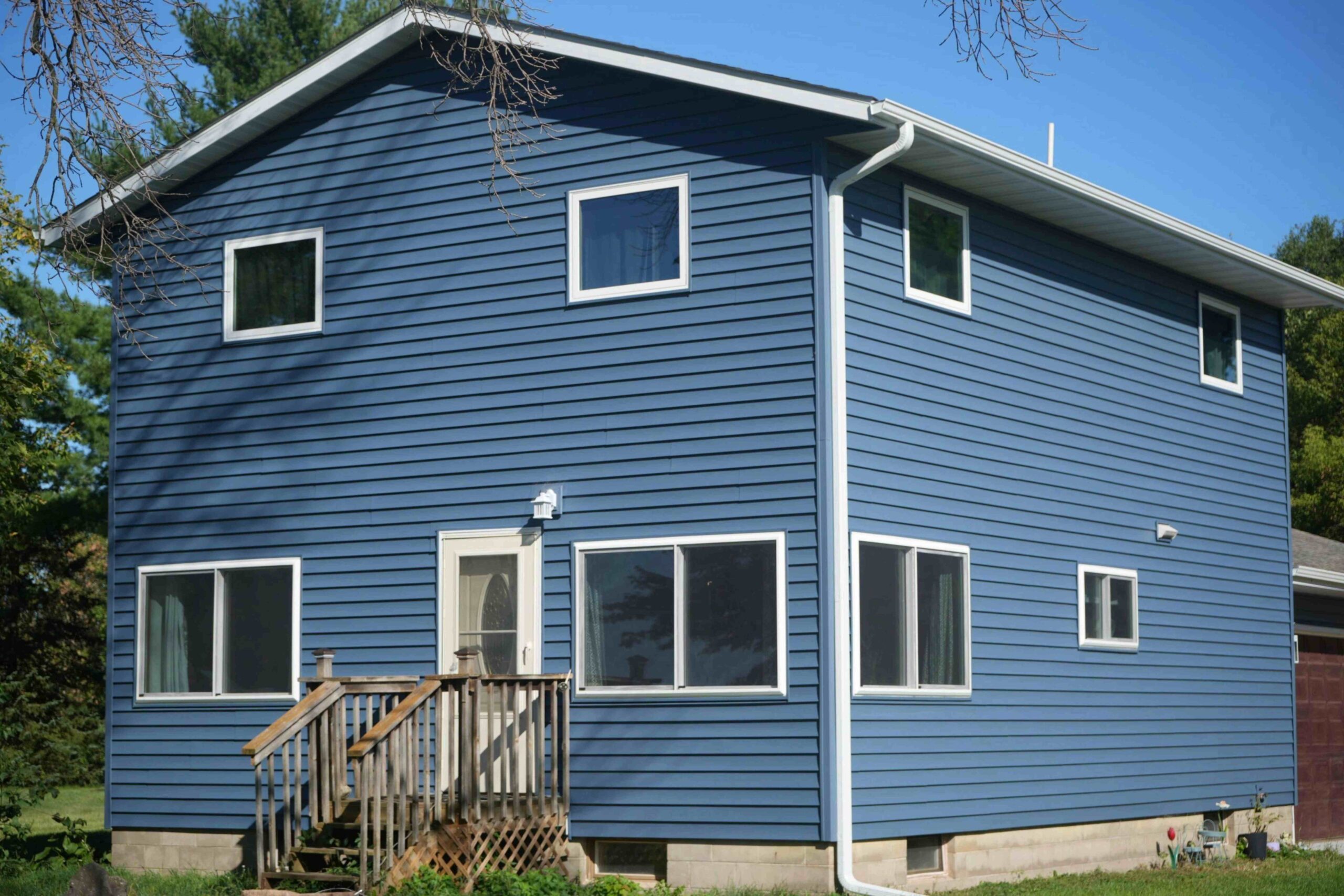 Professional Exteriors Inc. replaced Wisconsin farmhouse with new blue siding